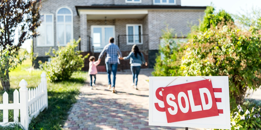 family walking up to their new home