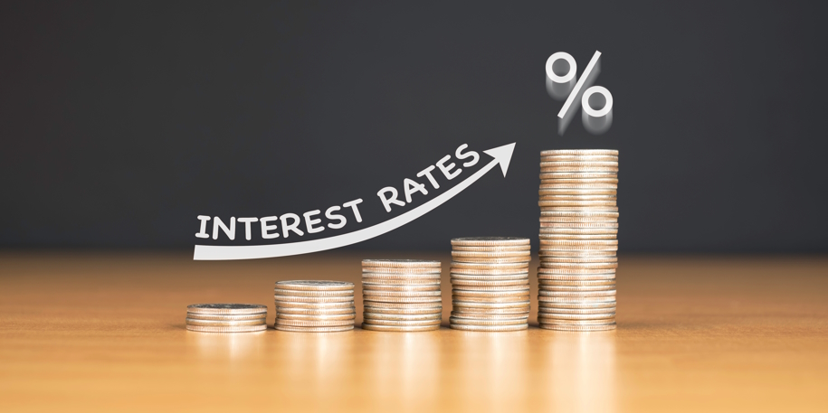 stacked quarters on a table as a symbol for increasing interest rates