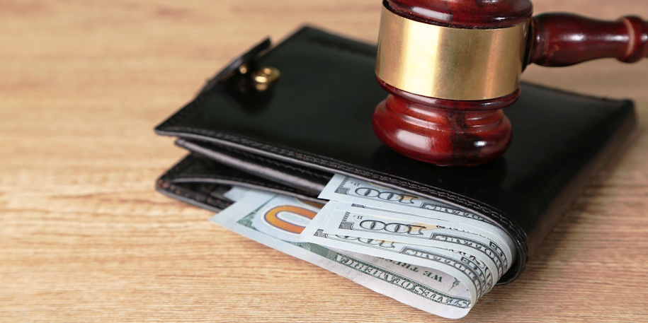 judge's gavel on wallet with cash