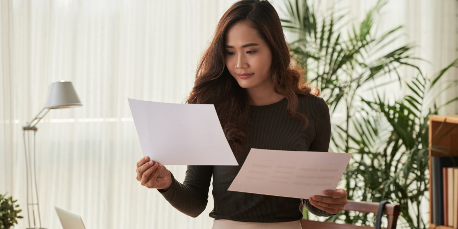 business woman comparing information in two documents