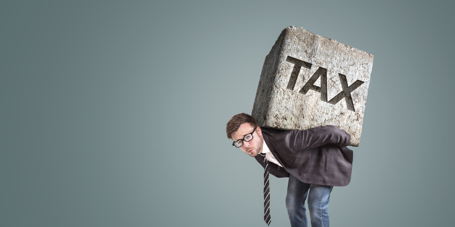 Businessman carrying a large and heavy stone on his back