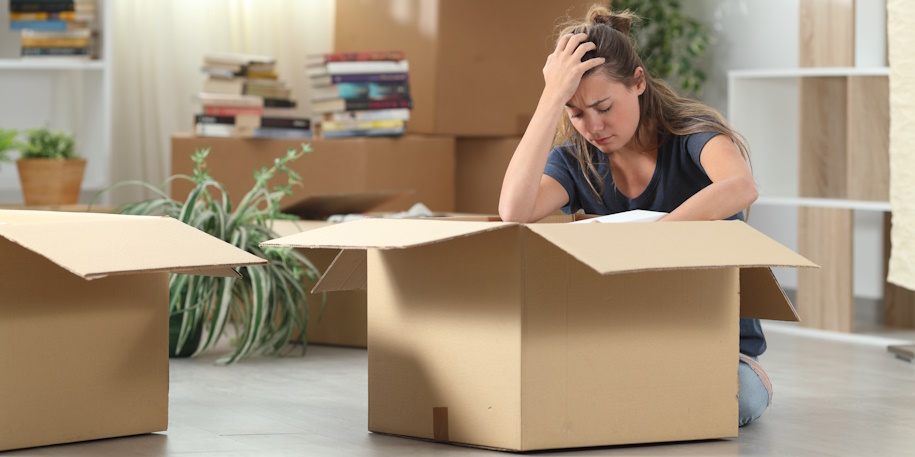 woman sadly packs up her home